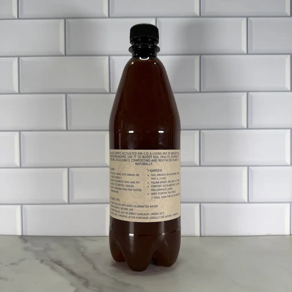 Bottle with a label detailing the uses of EM-1 on a tiled wall background