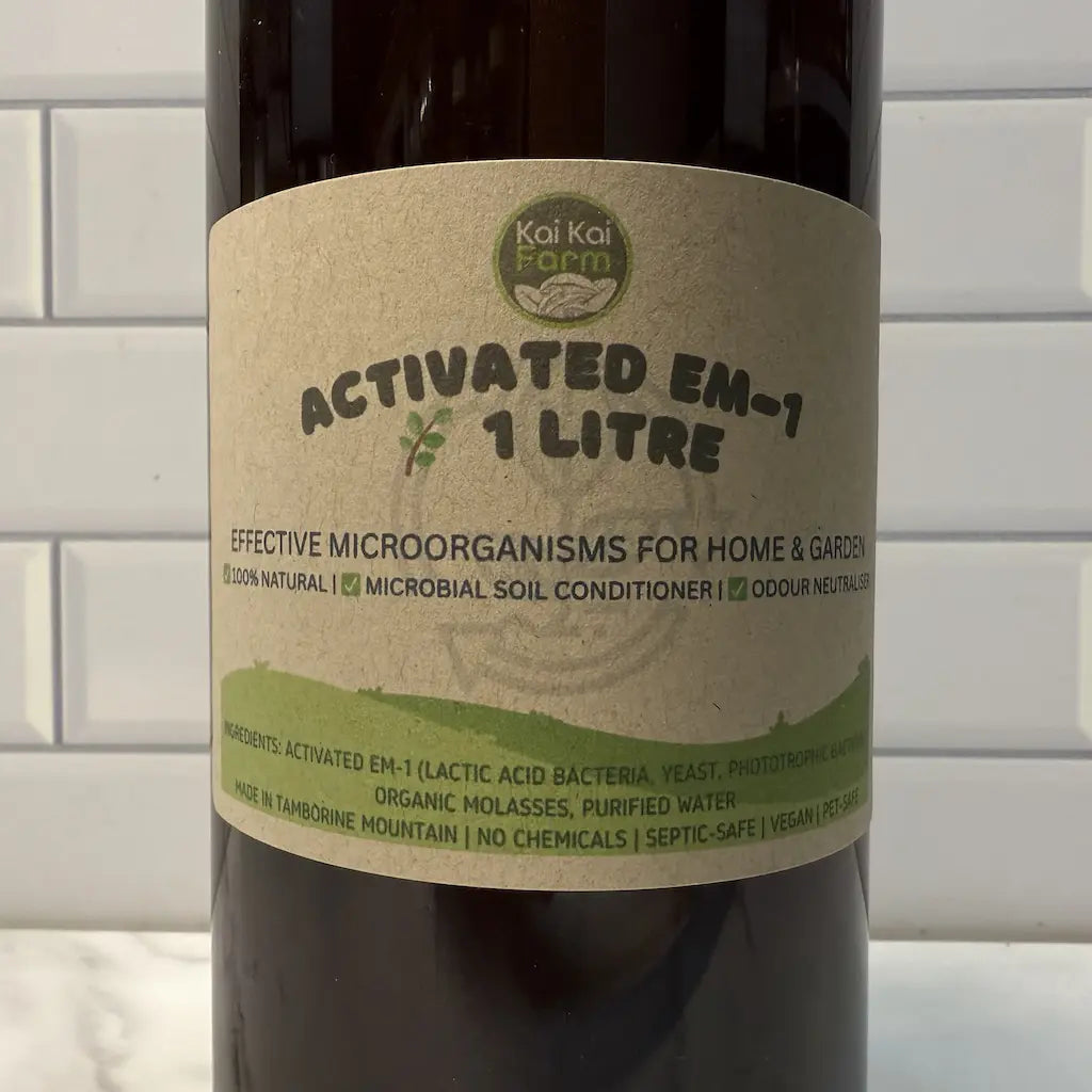 1L bottle of Kai Kai Farm Activated EM-1 with a label on a tiled wall background