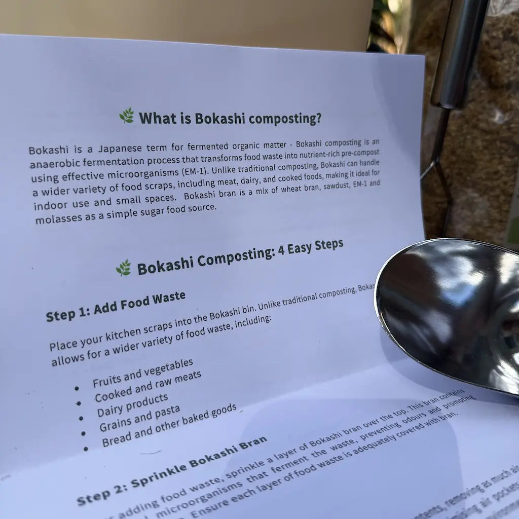 Sheet of paper with information about bokashi composting and a metal scoop on a white surface.