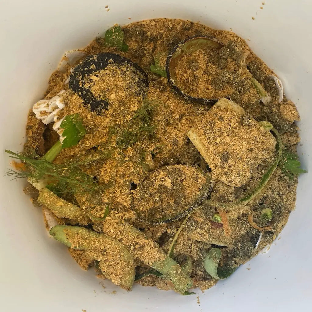 Layer of Bokashi Bran Mix covering food waste in the Bokashi Bin