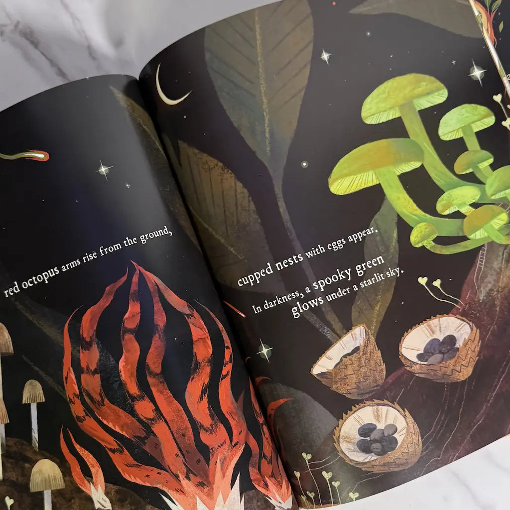 Illustrated book open to pages with amazing fungi and plants
