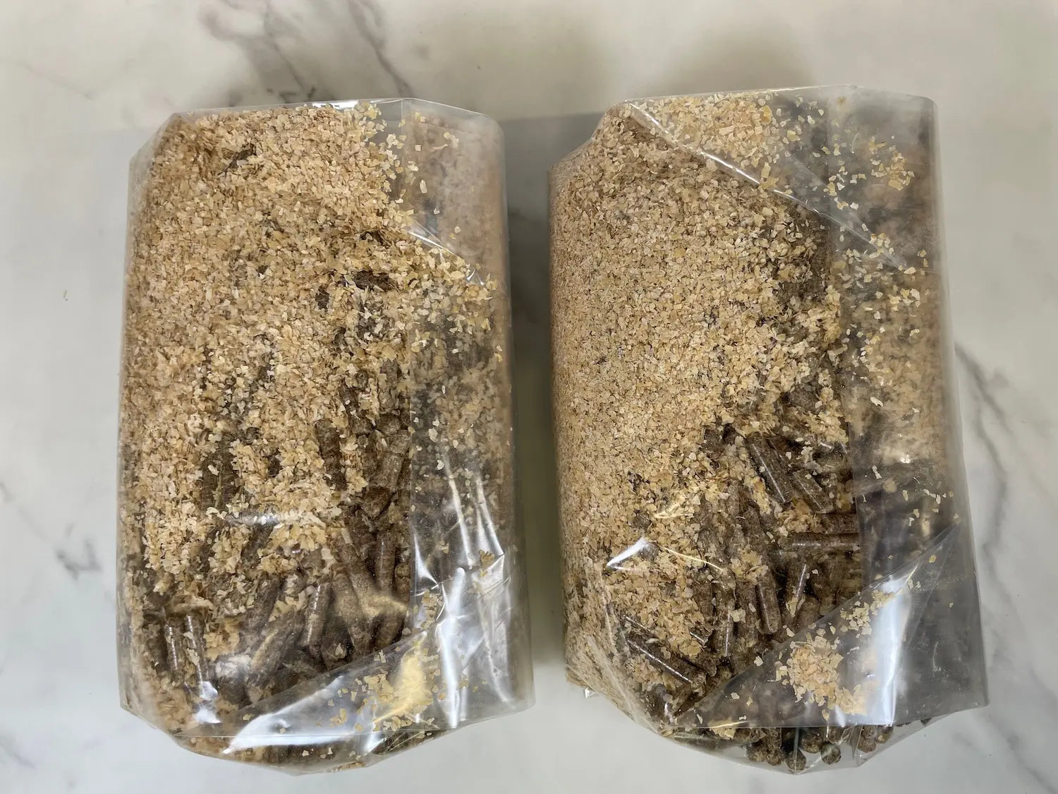 Two bags of dry mushroom substrate including organic wheat bran